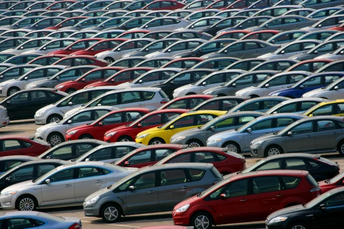 A large group of cars parked in a lot.